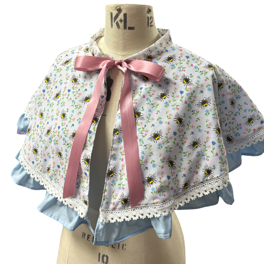 “Miriam” Capelet with ruffle and lace trim in White Bee print