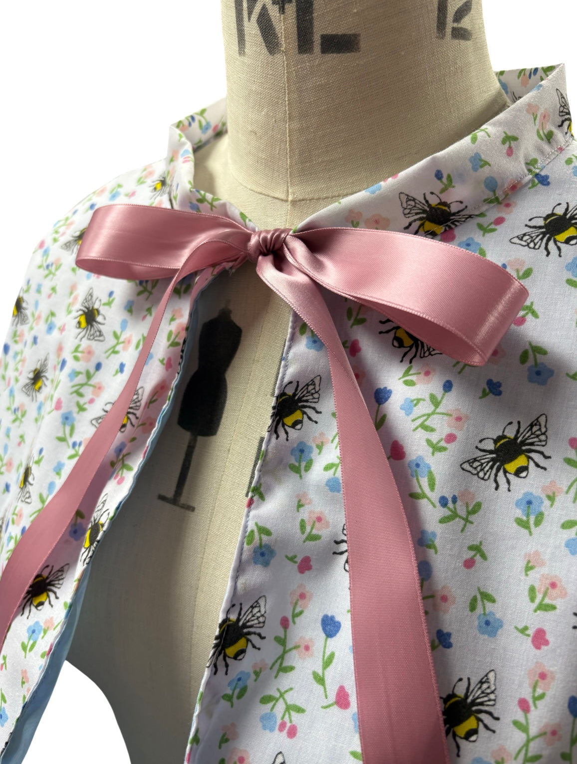 “Miriam” Capelet with ruffle and lace trim in White Bee print