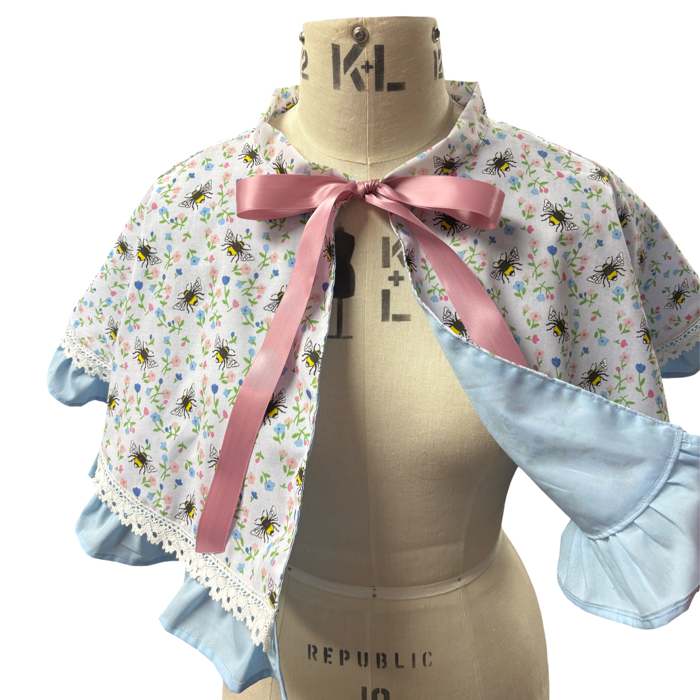 “Miriam” Capelet with ruffle and lace trim in White Bee print
